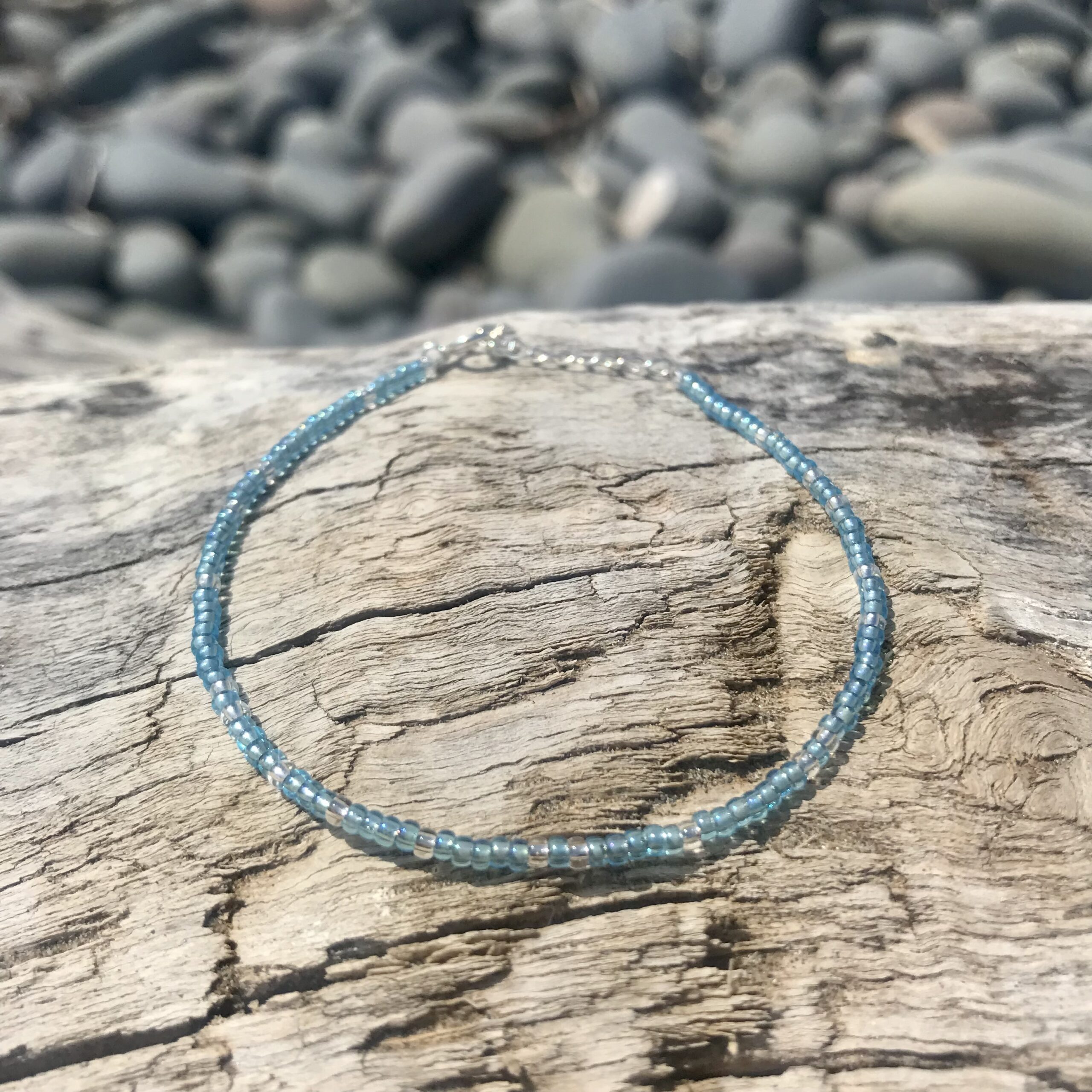 Sky Drift Beaded Bracelet by the shore.