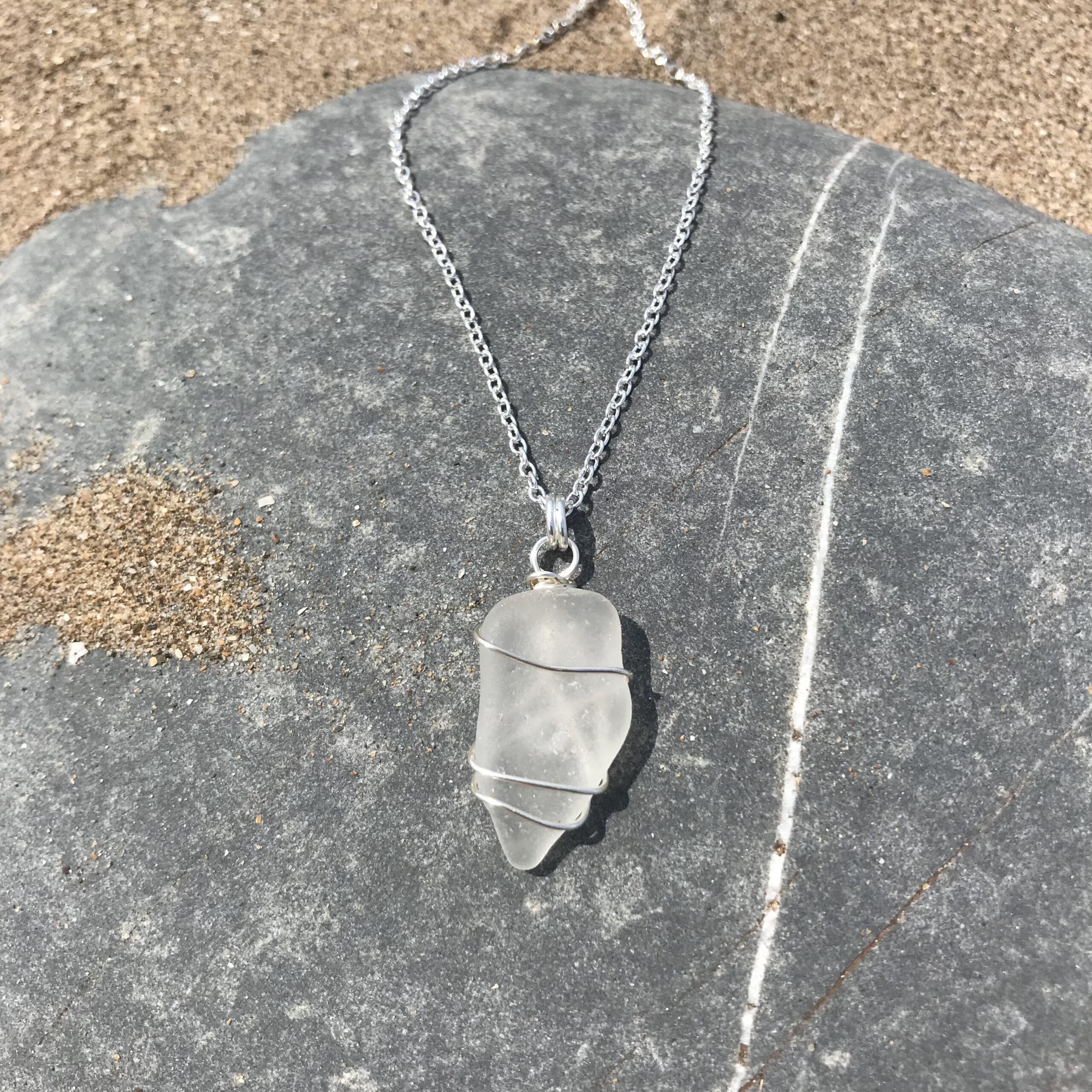 Handmade white sea glass necklace with sterling silver-plated chain, featuring naturally smoothed sea glass from the North Devon coast.