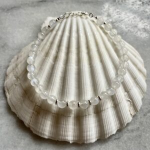 Moonstone and sterling silver bracelet styled on a scallop shell with a beach-inspired aesthetic.