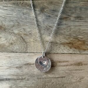 Sterling silver hammered disk necklace with heart.